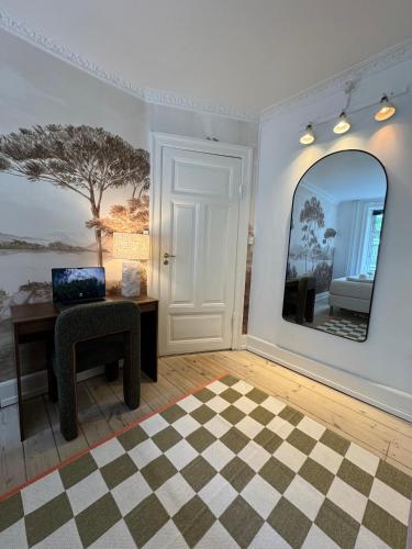a room with a desk and a mirror at Stylish Apartment with Rooftop in Trendy Vesterbro in Copenhagen