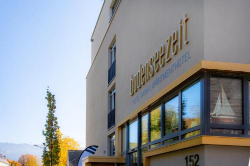 a building with a sign on the side of it at bodenseezeit Apartmenthotel Garni in Lindau