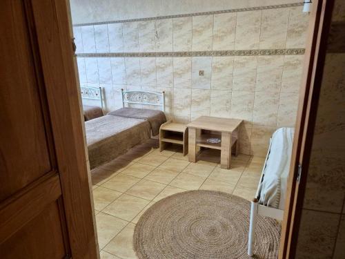 a small room with two beds and a table at Pechersk House in Kyiv