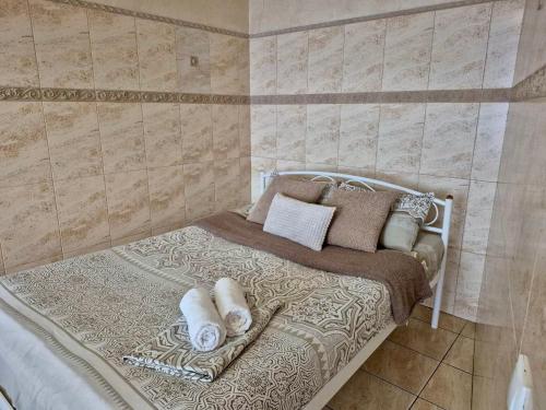 a bedroom with a bed with pillows on it at Pechersk House in Kyiv