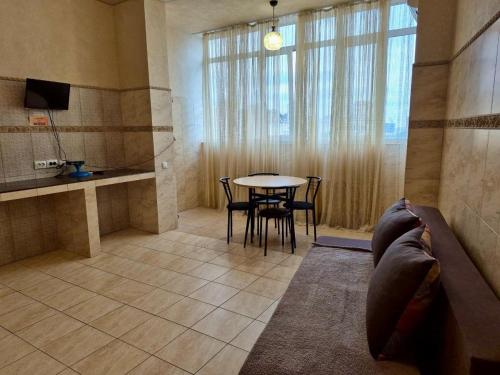 a living room with a table and a couch in a room at Pechersk House in Kyiv