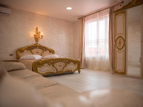 a bedroom with two beds and a window at AMSTERDAM hotel&swimming pool in Suprunovka