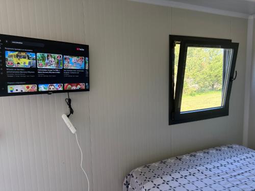 a room with a bed and a window and a wall at Mobilna kucica M in Donji Štoj
