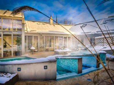 a house with a swimming pool in front of it at Vadstena Klosterhotell Konferens & Spa in Vadstena