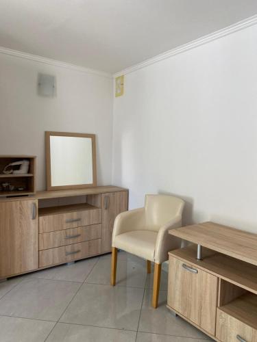 a living room with a chair and a table at Villa Rezevici in Katun