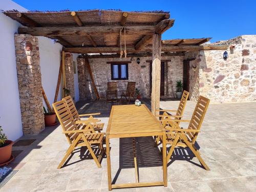 a wooden table and chairs on a patio at La Montañeta - Tefia Suites in Tefía
