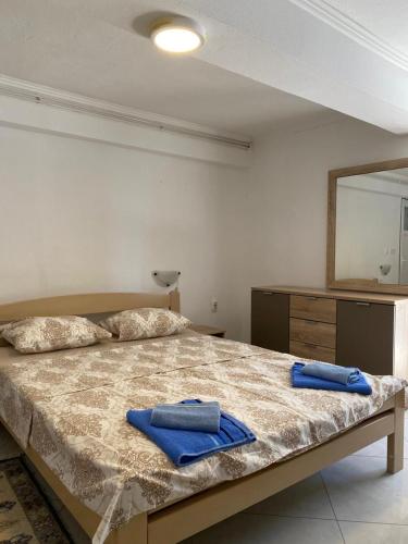 a bedroom with a bed with blue towels on it at Villa Rezevici in Katun
