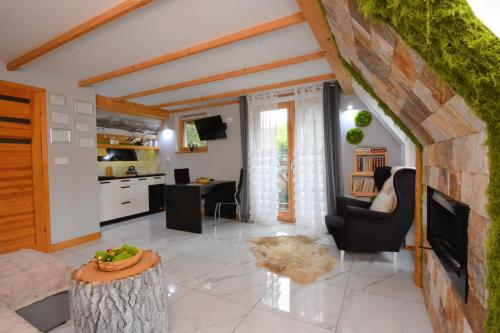 a living room with a couch and a table at Lux Houses w DOMKU tylko DWA APARTAMENTYz jacuzzi zewnętrznym in Groń