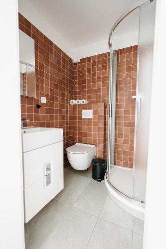 a bathroom with a toilet and a sink and a shower at Bytovka1962 in Manětín