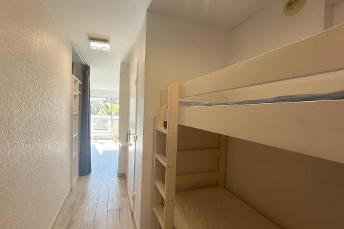 a room with two bunk beds and a hallway at Mas du Tanit - Escapade en bord de mer, terrasse & soleil in Antibes