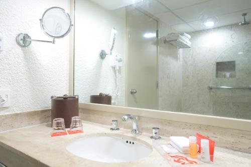 a bathroom with a sink and a mirror at Krystal Cancun in Cancún