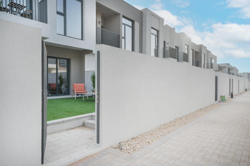 a row of apartment buildings with white walls at EasyGo- Lavish Townhouse with facilities in Dubai