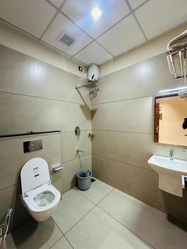 a bathroom with a toilet and a sink at THE HERiTAGE in Cochin