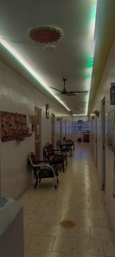 a row of benches sitting in a hallway at Nagendran Lodge in Virudunagar