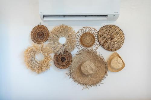 a group of straw hats on a white table at Casa Maria at Bigang Munti in San Juan