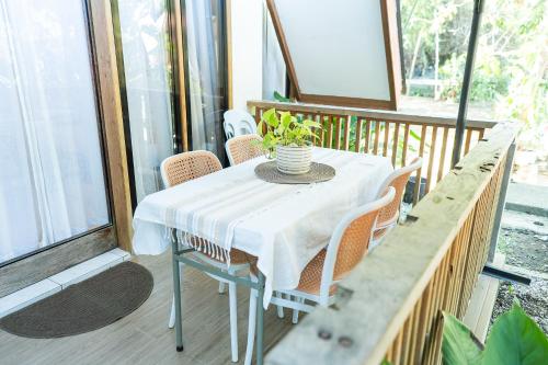 a white table and chairs on a porch at Casa Maria at Bigang Munti in San Juan