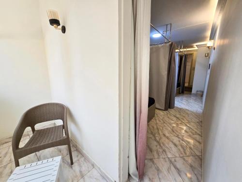 a hallway with a chair next to a door at Afnan Cairo Airport in Cairo
