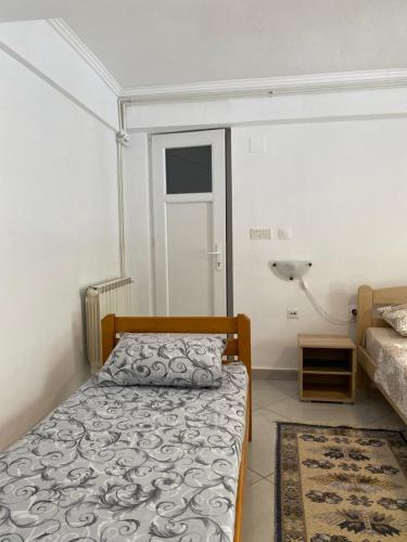a small bedroom with a bed and a lamp at Villa Rezevici in Katun