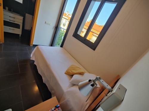a hospital room with a bed and a chair at Hostal Manel in Pineda de Mar