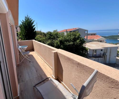 a chair sitting on the balcony of a building at Una Sky Apartment in Prijevor