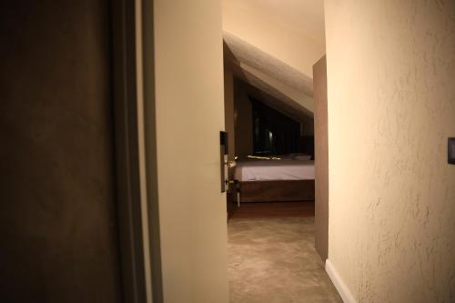 a hallway with a room with a bed in the background at Greco Boutique Hotel in Shkodër