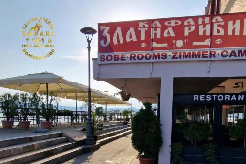 a building with a sign for a seafood restaurant at Kafana Zlatna Ribica in Golubac