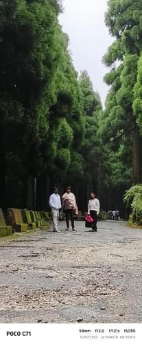 a group of people walking in a park at Mane Dara homestay in Darjeeling