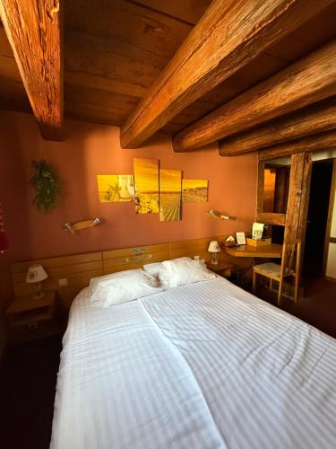 a bedroom with a large bed and a table at GC Frankstein in Dambach-la-Ville