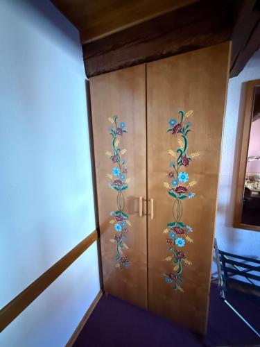 a wooden cabinet with peacocks painted on it at GC Frankstein in Dambach-la-Ville