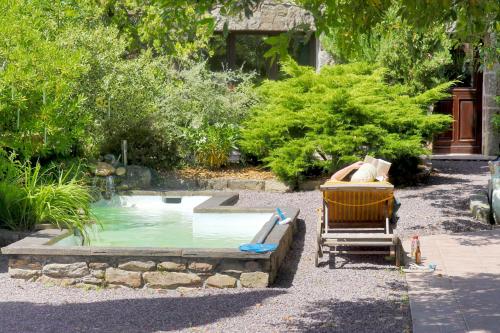 a small pool with a slide in a garden at Domaine de la Tranquillité V in Noyal-Muzillac