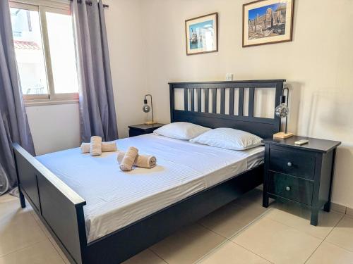 a bedroom with a bed with two pillows on it at Comfy 1 bed Apartment, great location 200Mbps WiFi in Paphos City