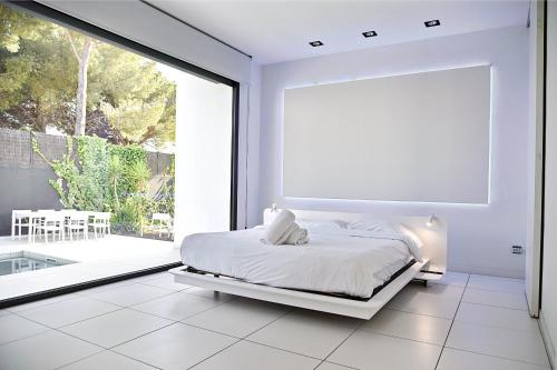 En eller flere senge i et værelse på Villa Blanca