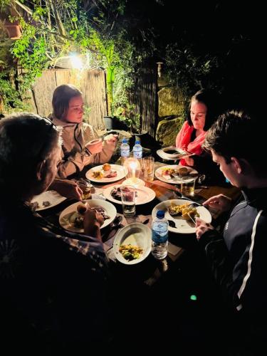 a group of people sitting around a table eating food at The Lake Frost in Nuwara Eliya