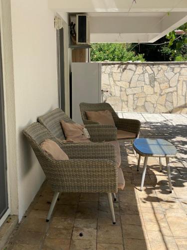 two chairs and a table on a patio at Villa Rezevici in Katun