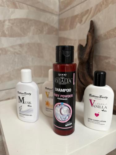 three bottles of hair products sitting on a shelf at Violeta in Agios Kirykos