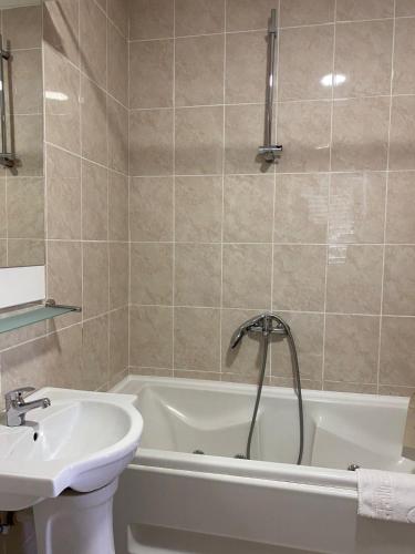 a bathroom with a sink and a tub and a sink at Villa Rezevici in Katun