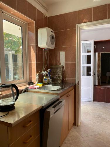 a kitchen with a sink and a counter top at Villa Rezevici in Katun