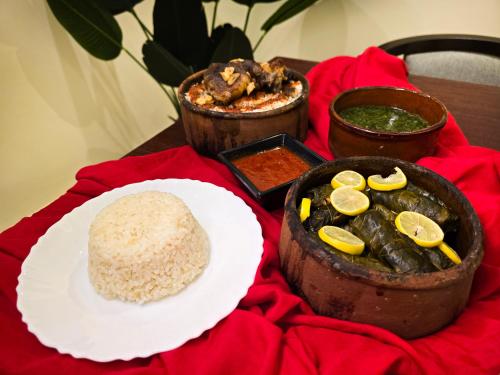 a table with a plate of food and a plate of rice at Afnan Cairo Airport in Cairo