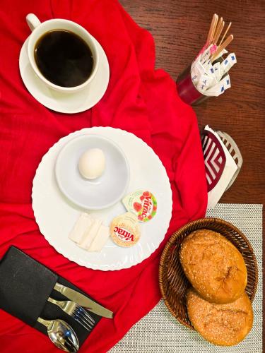 a table with a plate of food and a cup of coffee at Afnan Cairo Airport in Cairo