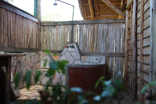 an outside view of a wooden building with a light at Leopard Rest Camp in Mbarara