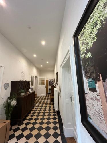 a hallway with a living room with a checkered floor at Landgasthof Zur Sonne in Enkirch