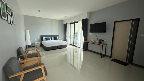 a bedroom with a bed and a television in it at B Villa 62 Rayong in Rayong