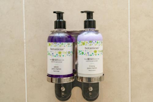 two bottles of hair products sitting on a wall at Hotel Nututun Palenque in Palenque