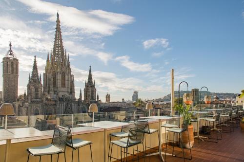 a balcony with chairs and a view of a city at Lamaro Hotel in Barcelona