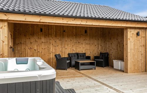 a pavilion with chairs and a tub on a deck at Amazing Home In Sæby With Sauna in Sæby