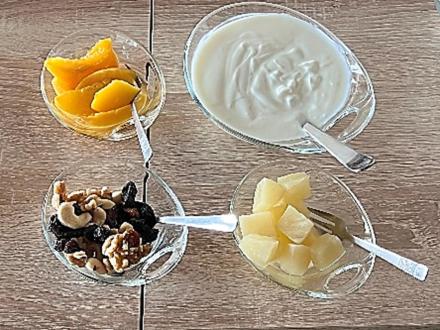 three bowls of food on a table with fruit and yogurt at Keutschacherhof in Keutschach am See