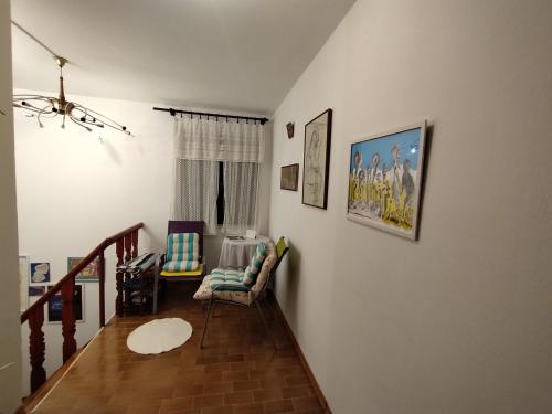 a living room with a couch and a chair at House with a garden 50m from the sea in Pag