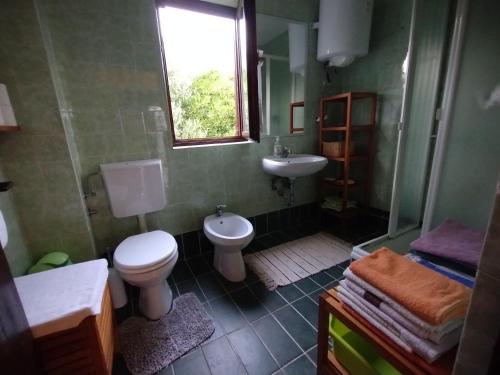 a bathroom with a toilet and a sink at House with a garden 50m from the sea in Pag
