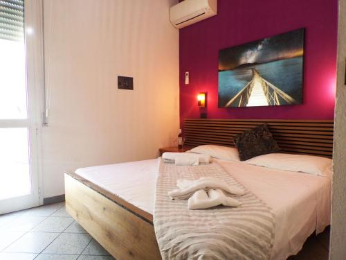a bedroom with two beds with towels on the bed at Hotel Litton Rimini nuova gestione in Rimini