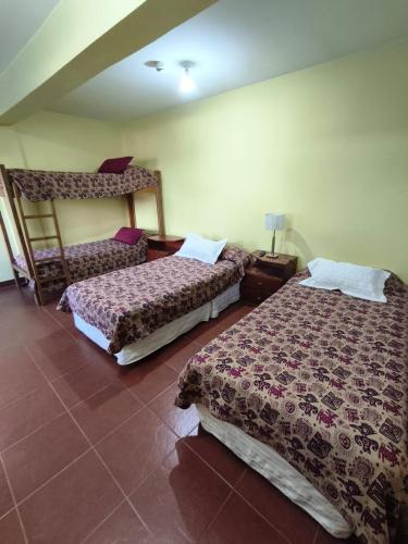 a room with two beds in a room at Hostal el Arroyito in Ushuaia
